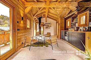 A wooden house with the word mountain base on the floor