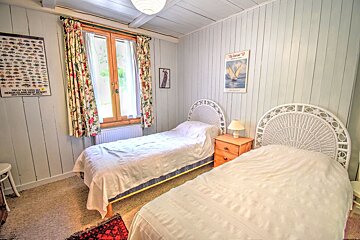 A bedroom with two beds and a poster on the wall that says french island sea resort