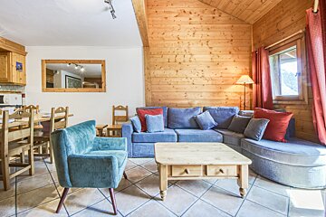 A living room with a couch and chairs and a coffee table