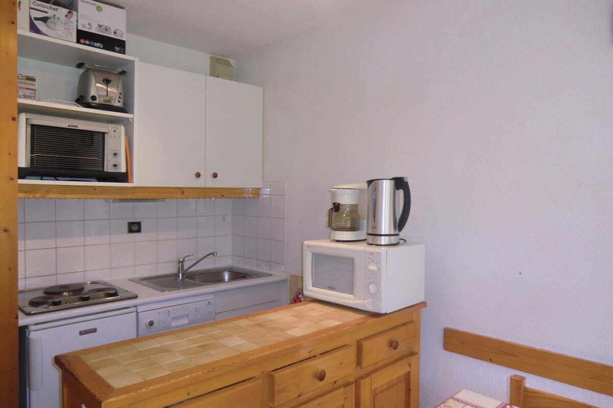 A kitchen with a microwave and a coffee maker