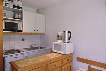 A kitchen with a microwave and a coffee maker