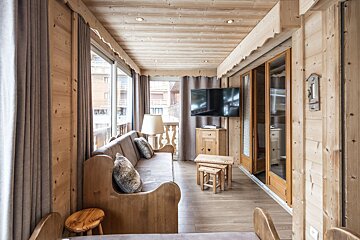 A living room with a couch and a flat screen tv