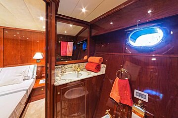 A bathroom on a boat with a sink and a mirror