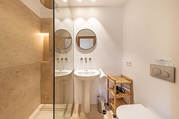 A bathroom with a sign on the wall that says 