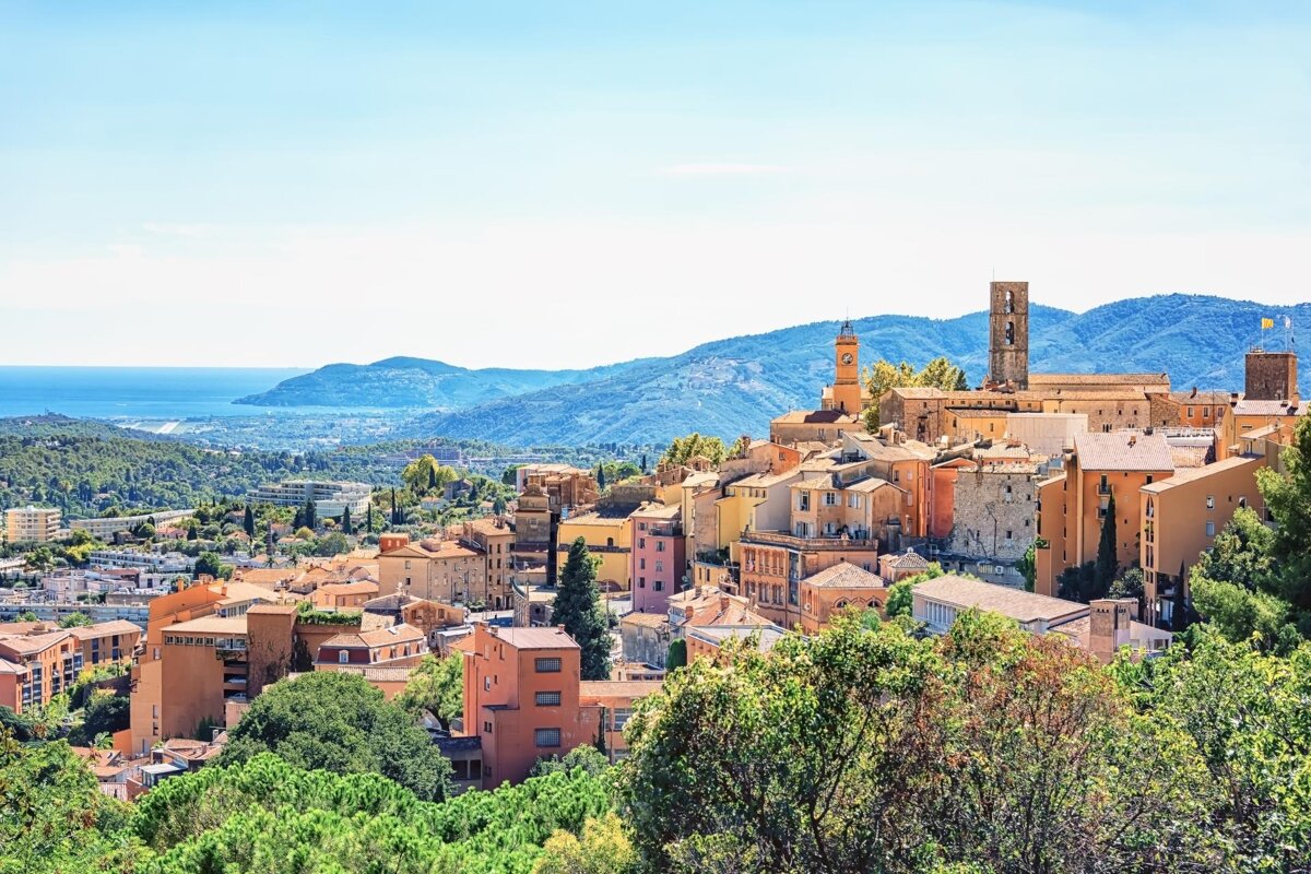 An aerial view of a small town with mountains in the background