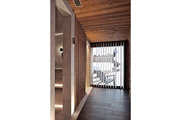 A hallway with wood paneling and a large window