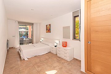 A bedroom with a large bed and two nightstands