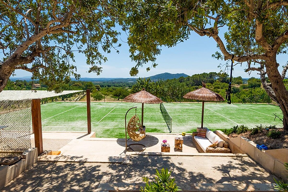 A view of a tennis court from a patio area