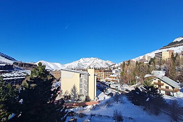 A view of a ski resort with mountains in the background