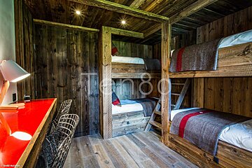 Bunk beds in a room with the number 80 on the wall