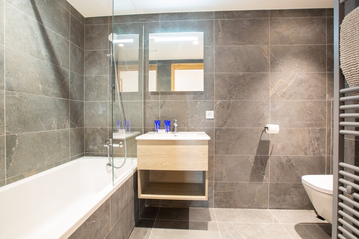 A bathroom with a bathtub a sink and a toilet