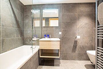 A bathroom with a bathtub a sink and a toilet