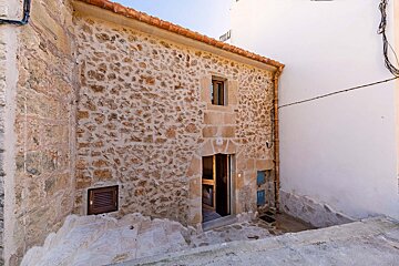 A stone building with stairs leading up to it