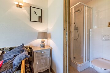 A bathroom with a sink a mirror and a shower