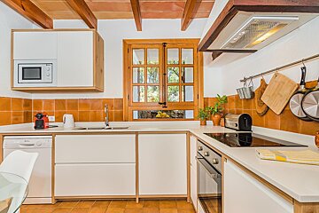 A kitchen with a stove top oven and a dishwasher