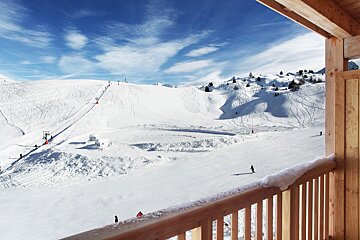 A view of a snowy mountain from a balcony
