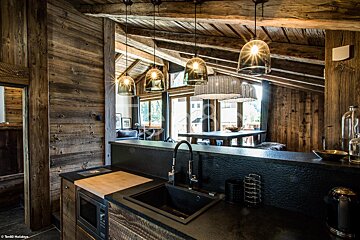 A kitchen with a sink and a cutting board