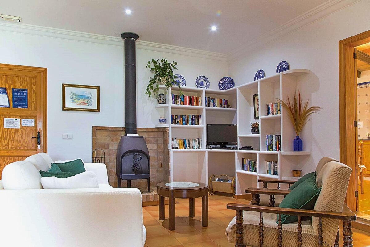 A living room with bookshelves and a fireplace