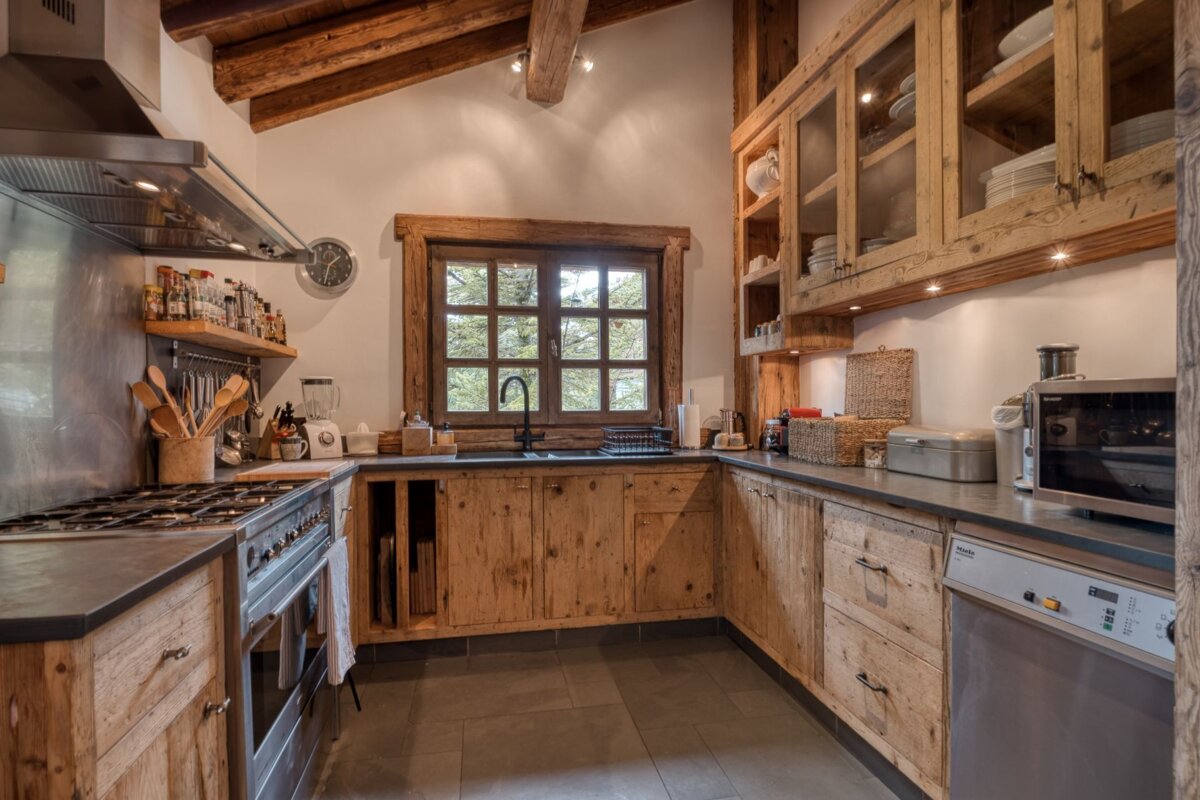 A kitchen with wooden cabinets and stainless steel appliances
