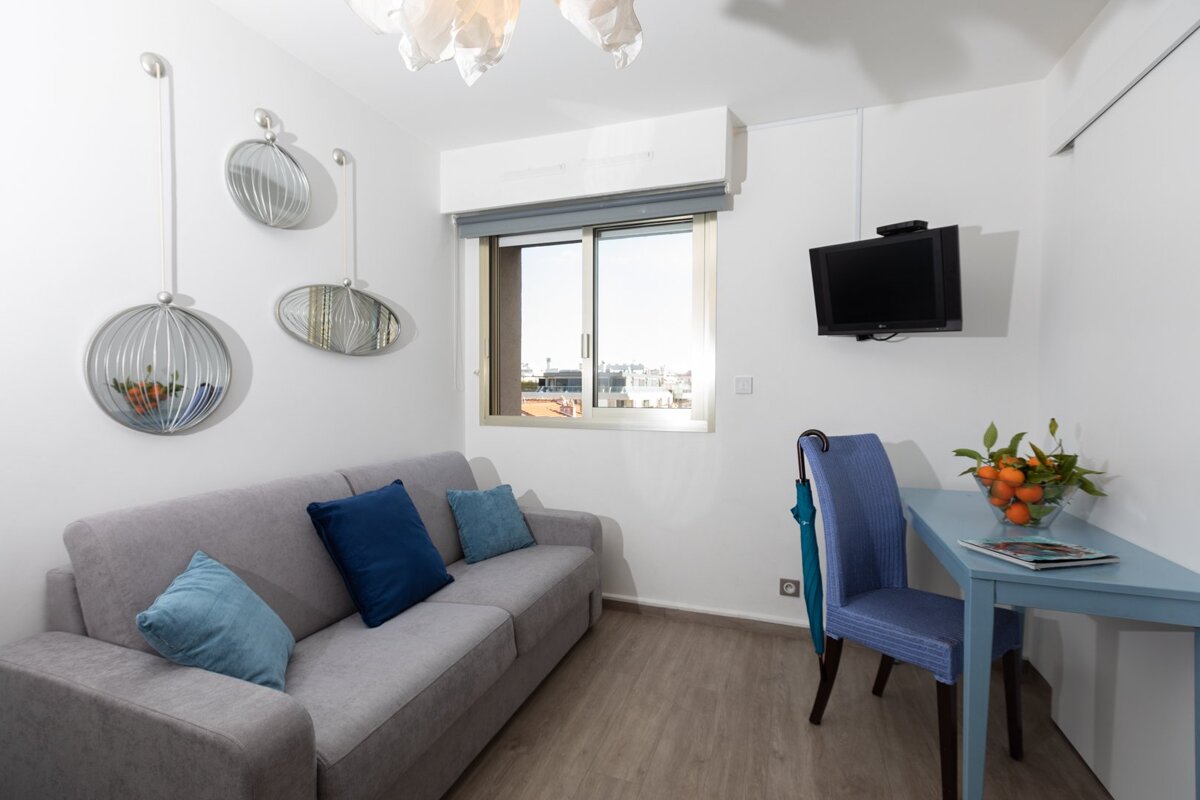 A small living room with a couch and a desk