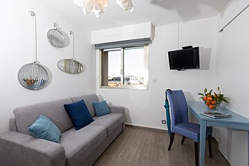 A small living room with a couch and a desk