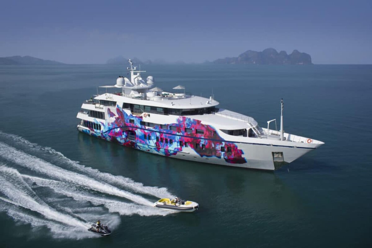 A large white yacht with a colorful design on the side