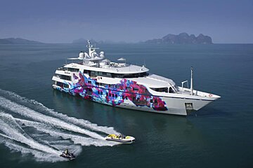 A large white yacht with a colorful design on the side