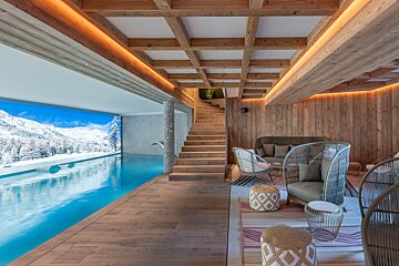 A swimming pool with a picture of snowy mountains on the wall