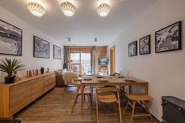 A dining room table with plates and glasses on it