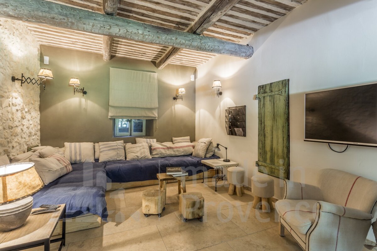 A living room with a couch and a television with the word provence on the wall