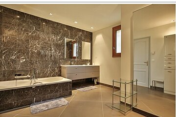 A bathroom with two sinks and a large mirror