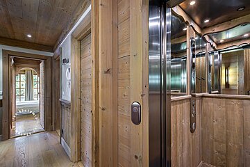 A stainless steel elevator in a wooden building
