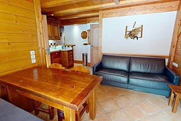 A living room with a couch and a wooden table
