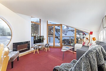 A living room with a couch a chair and a flat screen tv