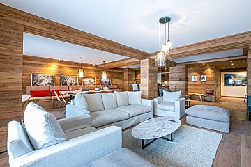A living room with a couch and chairs and a marble coffee table
