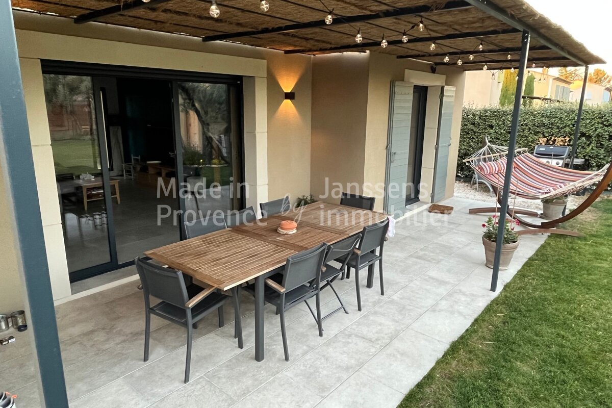 A patio with a table and chairs and the words made in provence on the bottom