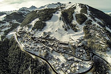 An aerial view of a ski resort in the mountains