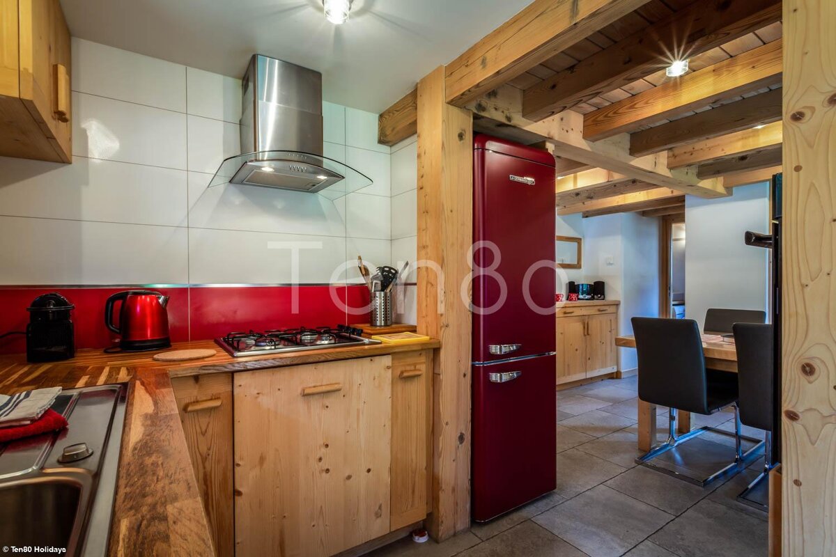 A kitchen with a red fridge that says turbo on it
