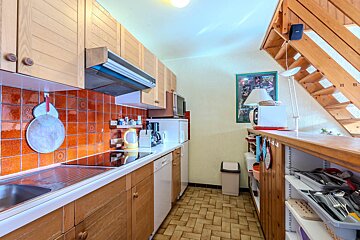 A kitchen with a picture on the wall that says 11