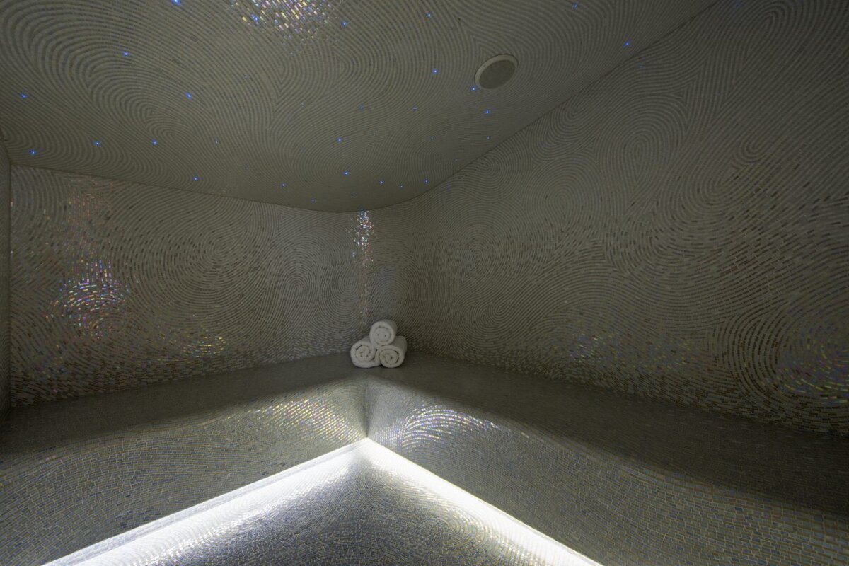A dimly lit room with towels on the floor