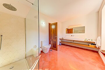 A bathroom with a toilet a sink and a shower