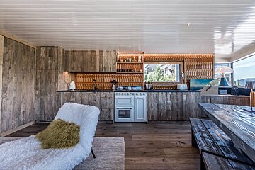 A kitchen with wooden cabinets and a white stove