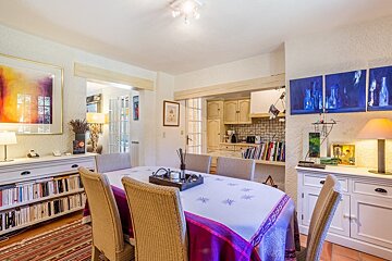 A dining room table with a purple table cloth