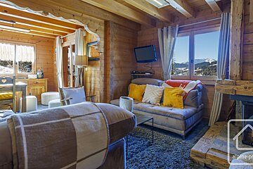 A living room with a couch a television and a fireplace
