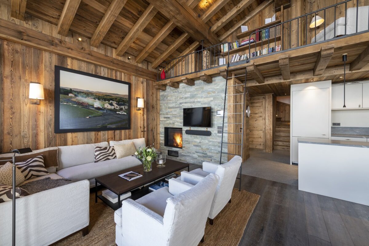A living room with a couch and chairs and a fireplace
