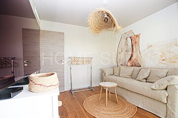 A living room with a couch and a rug and the word homes on the wall