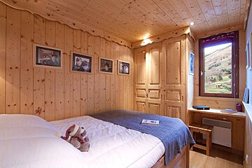 A bedroom with a bed and a book on it