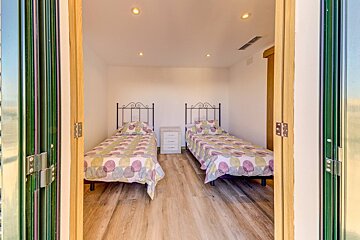 A bedroom with two twin beds and a nightstand