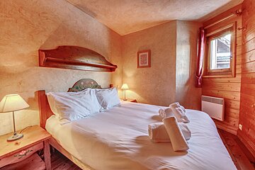 A bedroom with a bed and a picture on the wall that says home sweet home