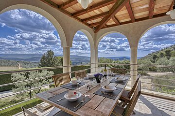 A dining table with a view of the mountains in the background